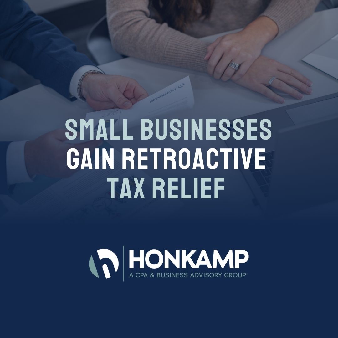 A close-up shot of a man handing a paper to a woman. On a dark overlay, the Honkamp logo and text reading 