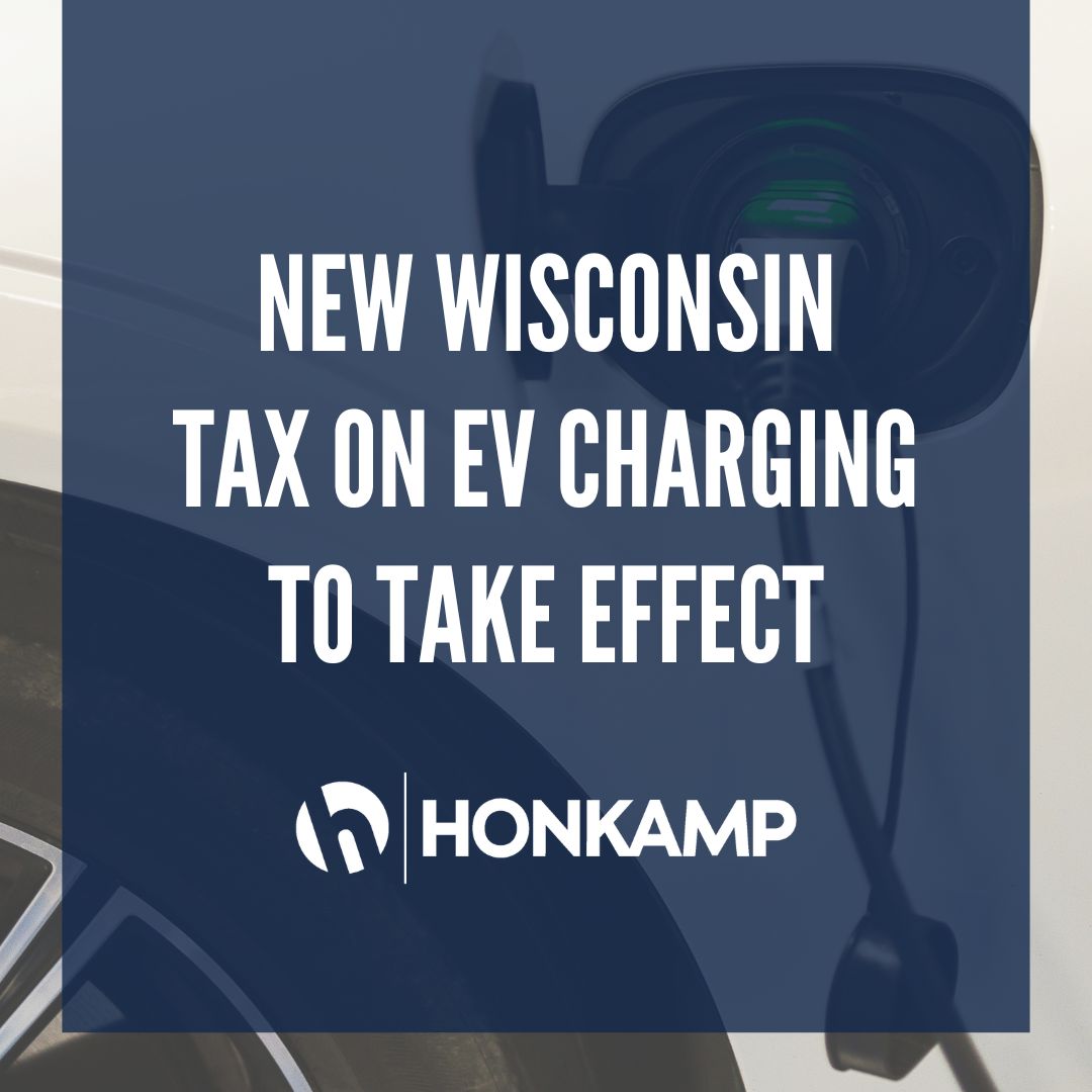 Close up image of an electric vehicle charging port with a dark overlay. The Honkamp logo and text reading 